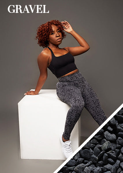 fit black woman posing for a woman owned black owned business wearing unique black activewear set that feature seamless scrunch butt high waist leggings and open back sports bra