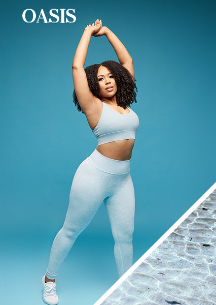 curvy fit black woman with curly hair posing for a woman-owned black owned business wearing unique teal activewear set that feature seamless scrunch butt high waist leggings and open back sports bra